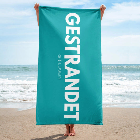 Super weiches goldsein Strandtuch "Gestrandet" in Türkis. Moderner Look für maximalen Strand-Komfort.