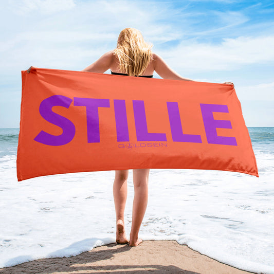 Weiches, modernes goldsein Strandtuch "Stille" in Koralle/Lila. Leicht und ideal für die Reise.