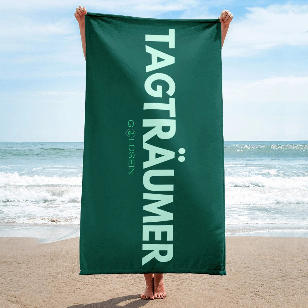 Weiches, modernes goldsein Strandtuch "Tagträumer" in Grün. Ein stilvolles und bequemes Accessoire für deinen Tag am Meer.